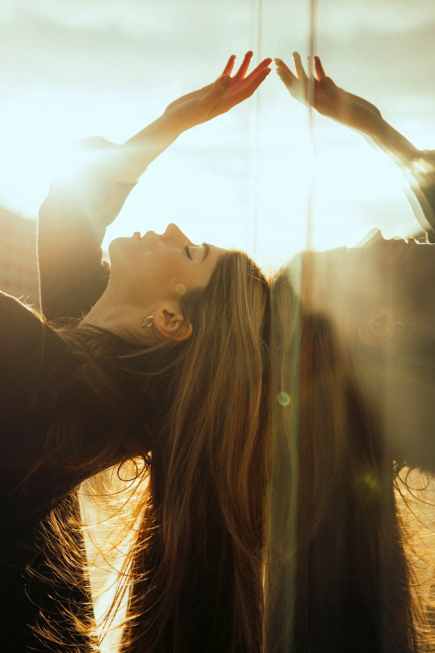 Woman and her reflection in warm city light